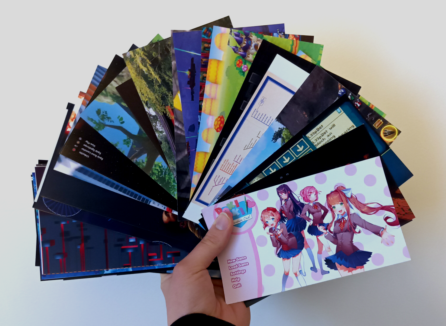 photographie d'un éventail de cartes sur lesquelles sont imprimés des images de différents jeux vidéo, notamment new super mario bros